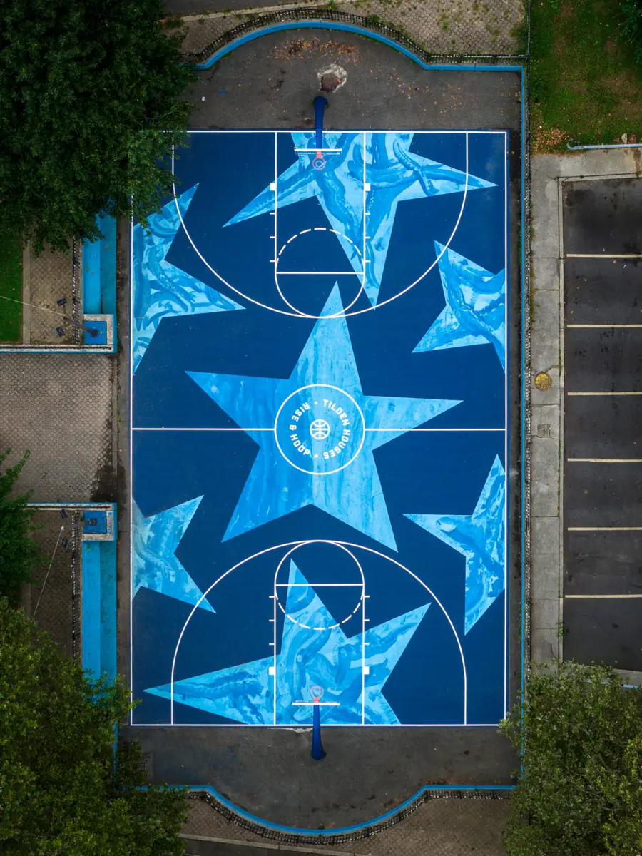 The Seven Stars Court at Tilden Houses from directly above after restoration, deep blue with large pale blue stars and a centre circle reading Tilden Houses, Rise and Hoop